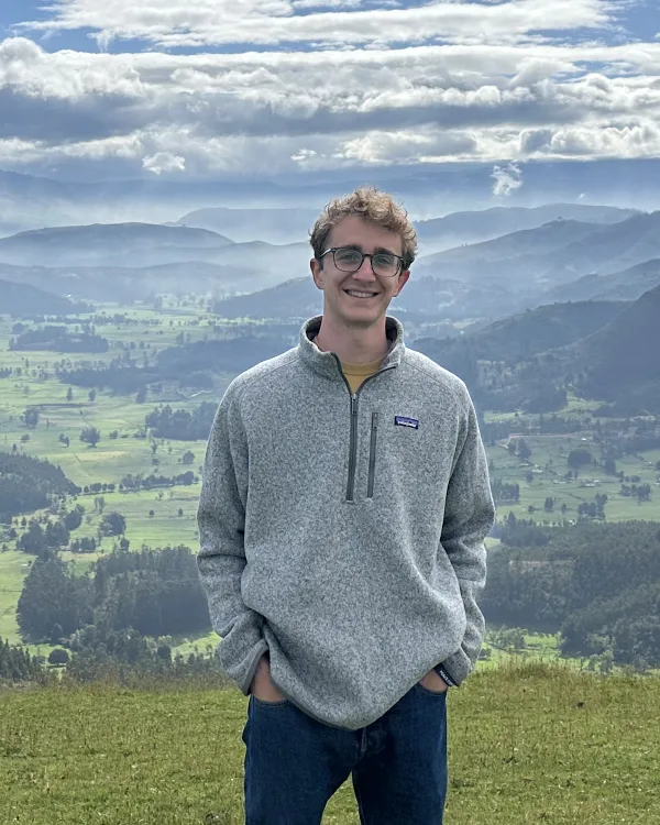 Caleb Shenk standing in the mountains of Colombia